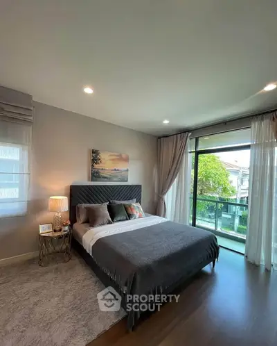 Luxurious bedroom with modern decor and large window offering a serene view, perfect for relaxation.