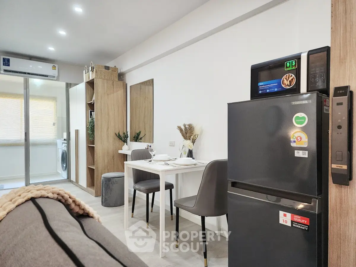 Modern apartment interior with dining area and kitchen appliances