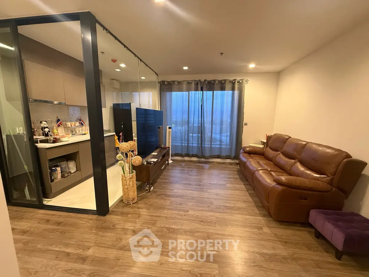 Spacious living room with modern open kitchen and elegant wooden flooring