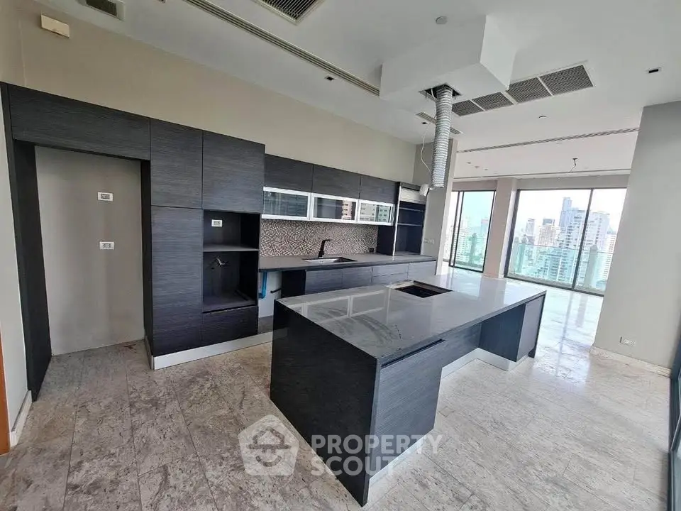 Luxurious modern kitchen with sleek dark cabinetry and stunning city view.