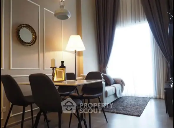 Elegant living room with high ceilings and modern decor, featuring a cozy dining area and ample natural light.