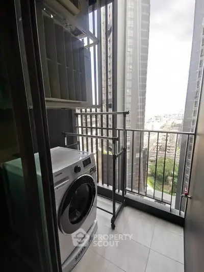 Modern apartment balcony with washing machine and city view