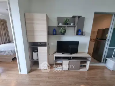 Modern living room with stylish shelving and TV unit, adjacent to a cozy bedroom with natural light.