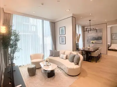 Luxurious open-plan living and dining area with elegant decor and natural light.