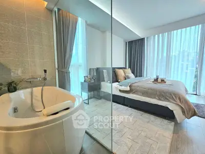 Luxurious bedroom with modern bathtub and floor-to-ceiling windows