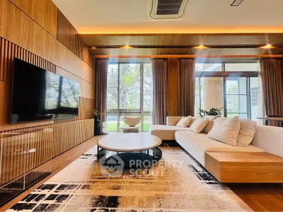 Luxurious modern living room with large windows and stylish wooden accents.