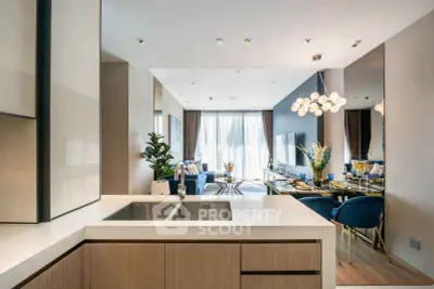 Luxurious open-plan living room with modern kitchen and elegant dining area, featuring stylish decor and ample natural light.