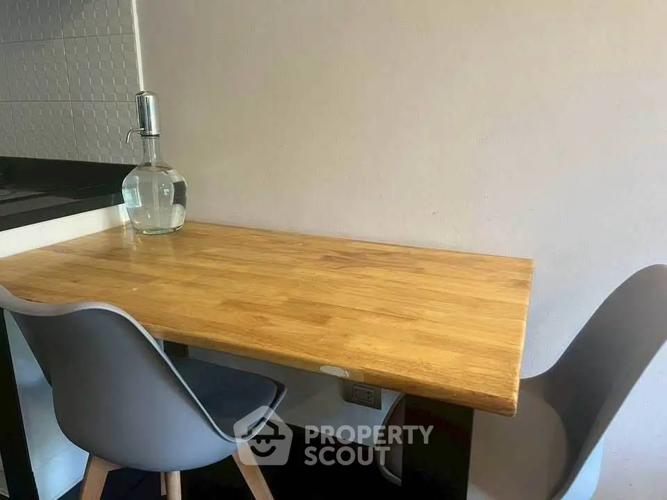 Modern kitchen corner with wooden table and stylish chairs, perfect for cozy dining experiences.