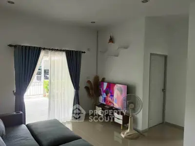 Modern living room with sleek decor and large window for natural light.