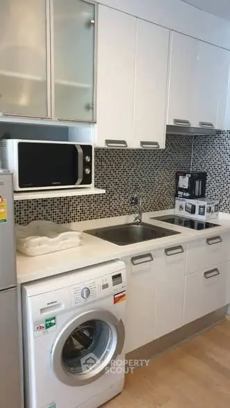 Modern kitchen with sleek white cabinets and built-in appliances