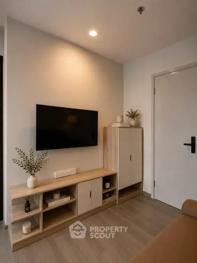 Modern living room with sleek TV setup and stylish wooden furniture