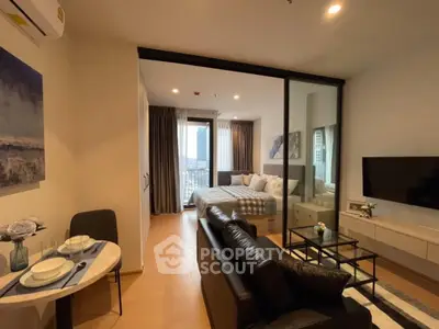 Modern studio apartment with open layout and city view, featuring stylish decor and cozy living space.