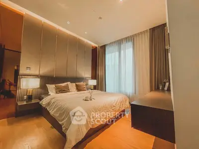 Luxurious bedroom with elegant lighting and modern decor, featuring a cozy bed and stylish furnishings.