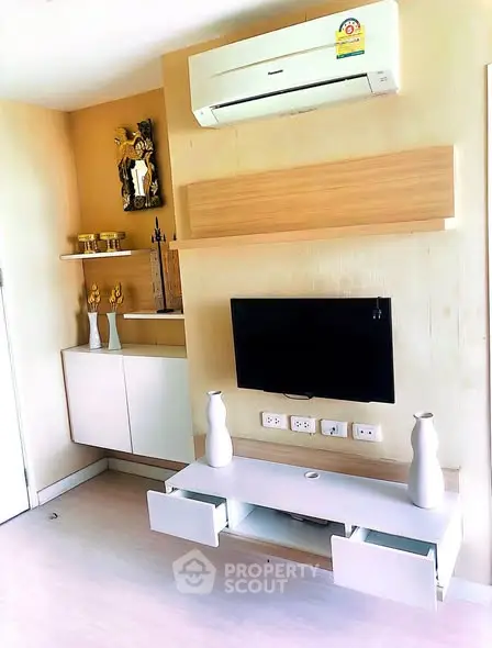 Modern living room with sleek TV setup and air conditioning unit.