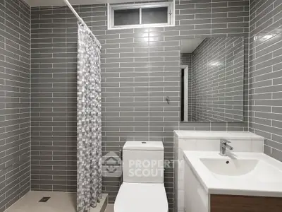Modern bathroom with sleek gray tiles and contemporary fixtures
