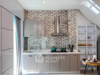 Modern kitchen with sleek cabinets and exposed brick wall design