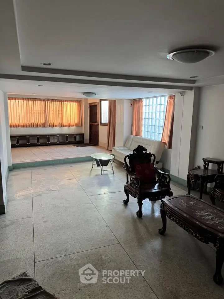 Spacious living room with elegant furniture and large windows for natural light.