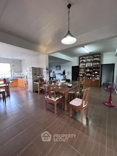 Spacious kitchen with open layout, ample cabinetry, and modern appliances, seamlessly transitioning to a cozy dining area with natural light.