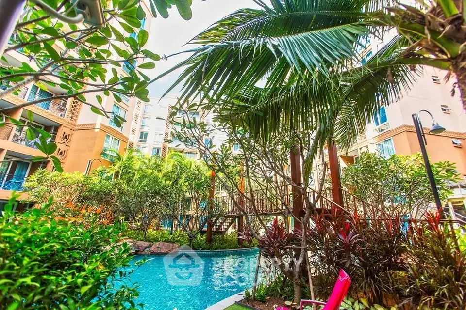 Lush tropical garden with pool in modern residential complex