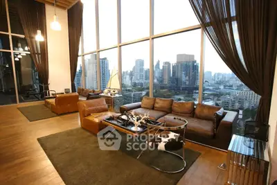 Luxurious living room with floor-to-ceiling windows and stunning city view in modern high-rise apartment.