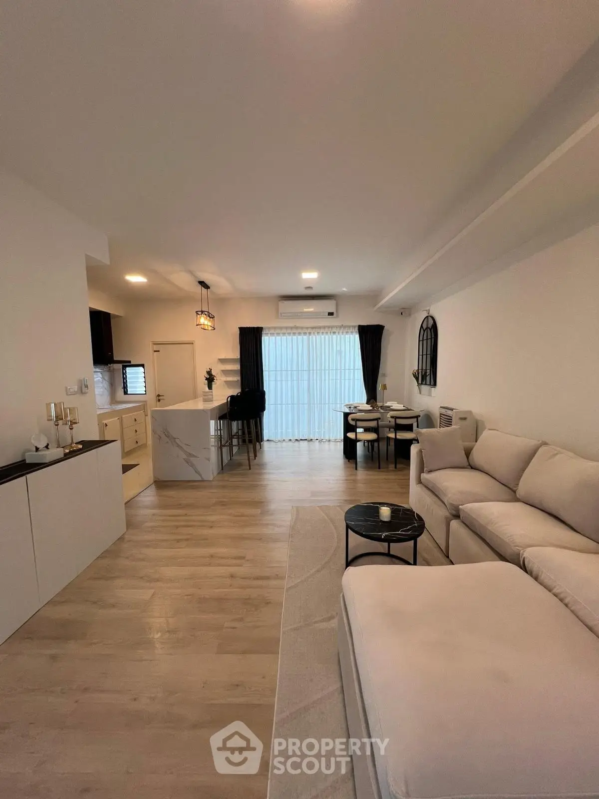 Spacious modern living room with open kitchen and elegant decor