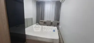 Modern minimalist bedroom with sleek furniture and ample natural light.