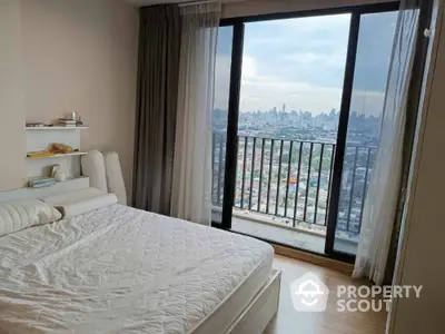 Spacious bedroom with stunning city view and large window balcony access