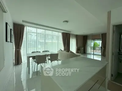 Spacious modern living room with large windows and elegant decor