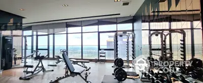 Luxury high-rise gym with panoramic city views and modern fitness equipment.