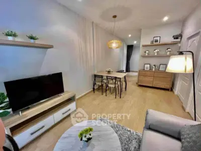 Modern living room with stylish decor and open dining area, featuring a cozy ambiance and contemporary furniture.