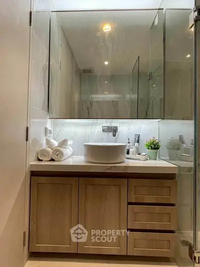 Modern bathroom with elegant vanity and stylish mirror in a contemporary home.