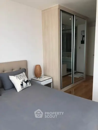 Modern bedroom with mirrored wardrobe and stylish decor