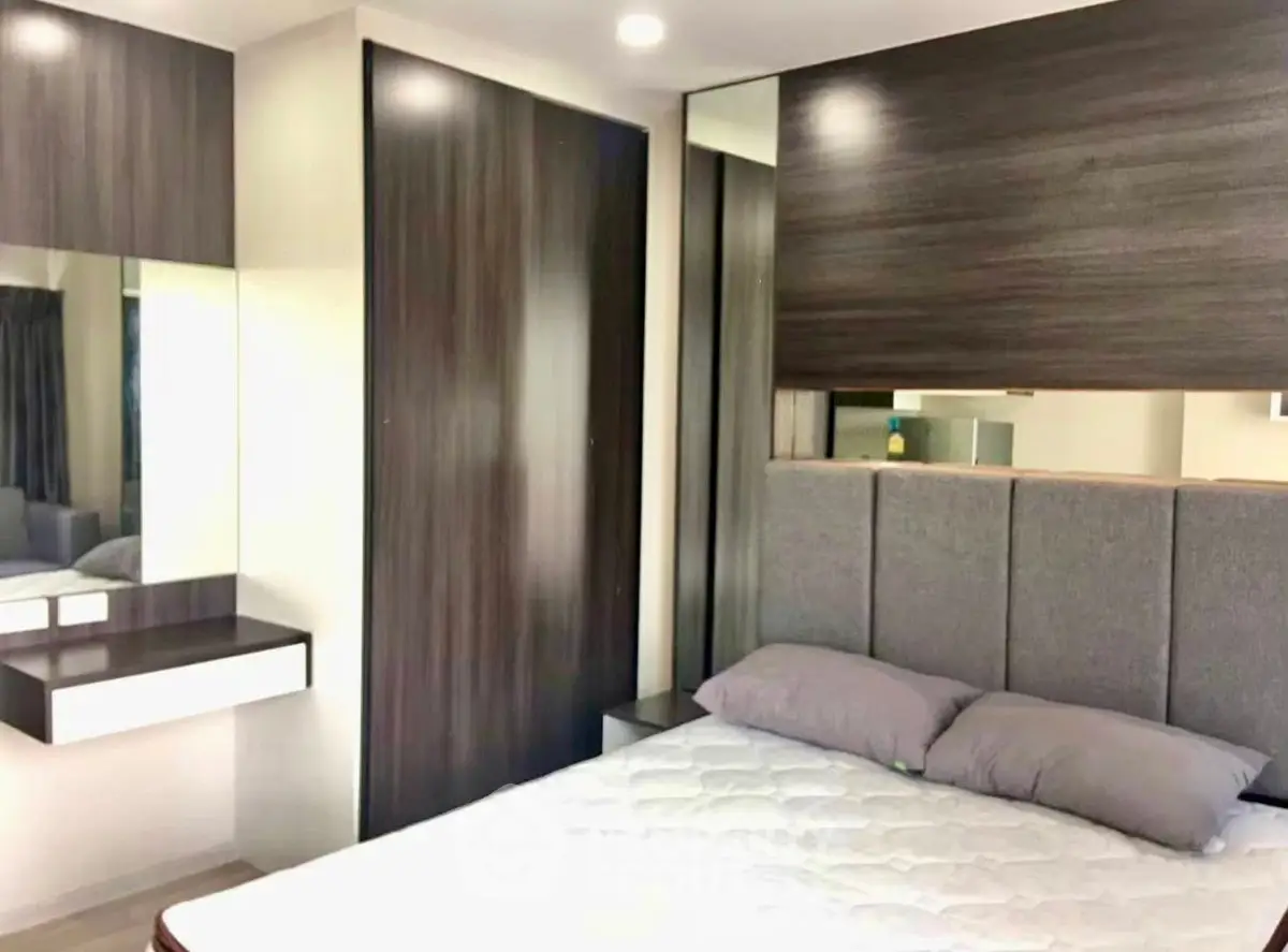 Modern bedroom with sleek design and stylish furnishings, featuring a comfortable bed and elegant decor.