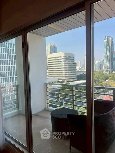 Spacious balcony with city view in modern high-rise apartment