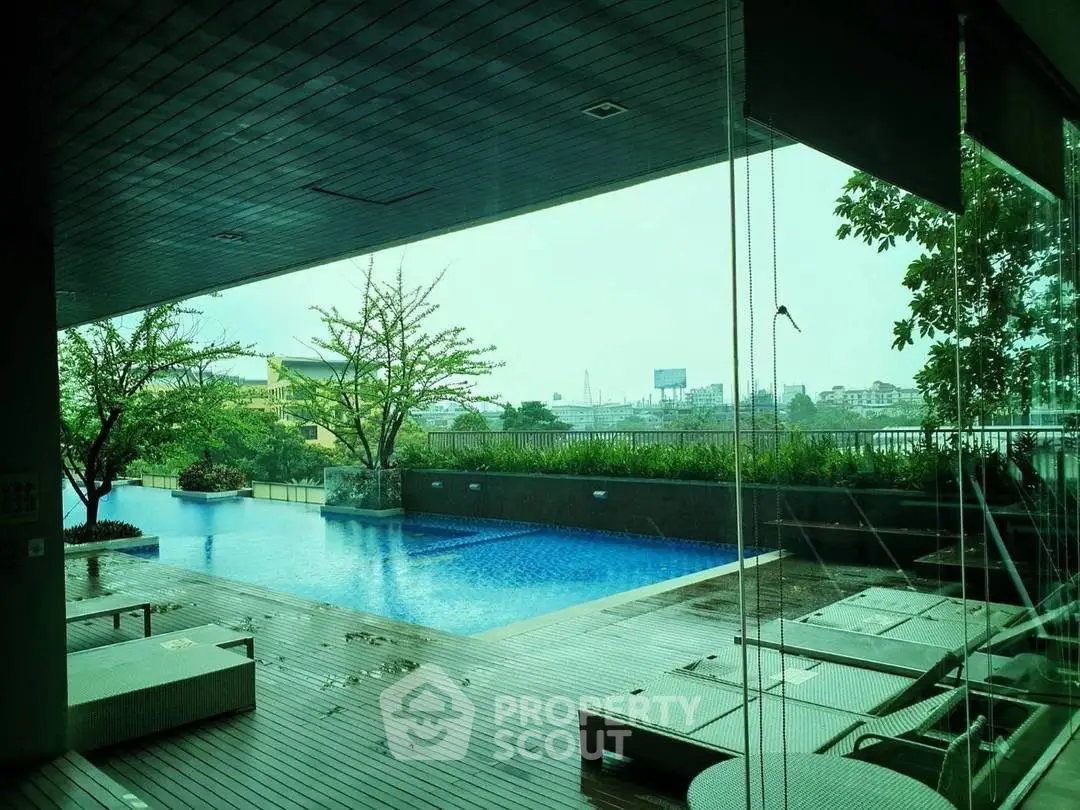 Luxurious rooftop pool with city view and modern deck seating, perfect for relaxation and leisure.