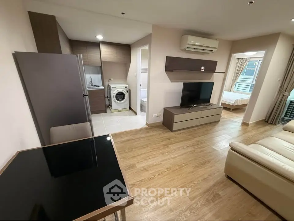 Modern open-plan living room with kitchen and bedroom in stylish apartment