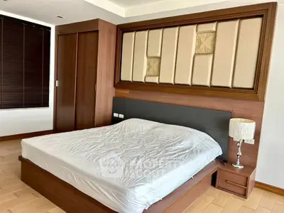 Spacious bedroom with modern wooden furniture and elegant decor