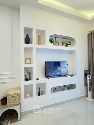 Modern living room with built-in shelves and sleek TV setup