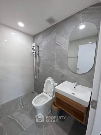 Modern bathroom with sleek gray tiles and contemporary fixtures