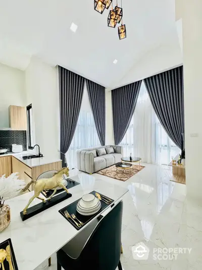 Luxurious open-plan living space with high ceilings, polished marble floors, and elegant dark drapes framing large windows, offering a sophisticated urban living experience.