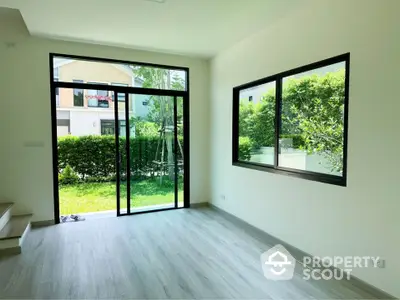 Bright and airy living room with large windows and garden view in modern home