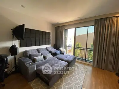 Spacious living room with cozy sectional sofa and large window view.