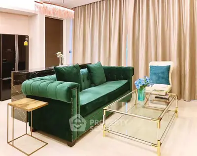 Luxurious living room with elegant green sofa and glass coffee table, perfect for modern living.