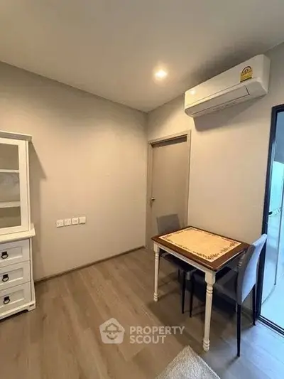 Cozy interior corner with air conditioning and compact dining setup in modern apartment.