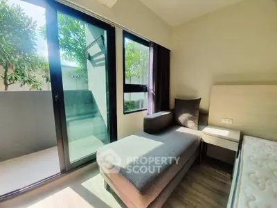 Bright bedroom with balcony access and modern furniture