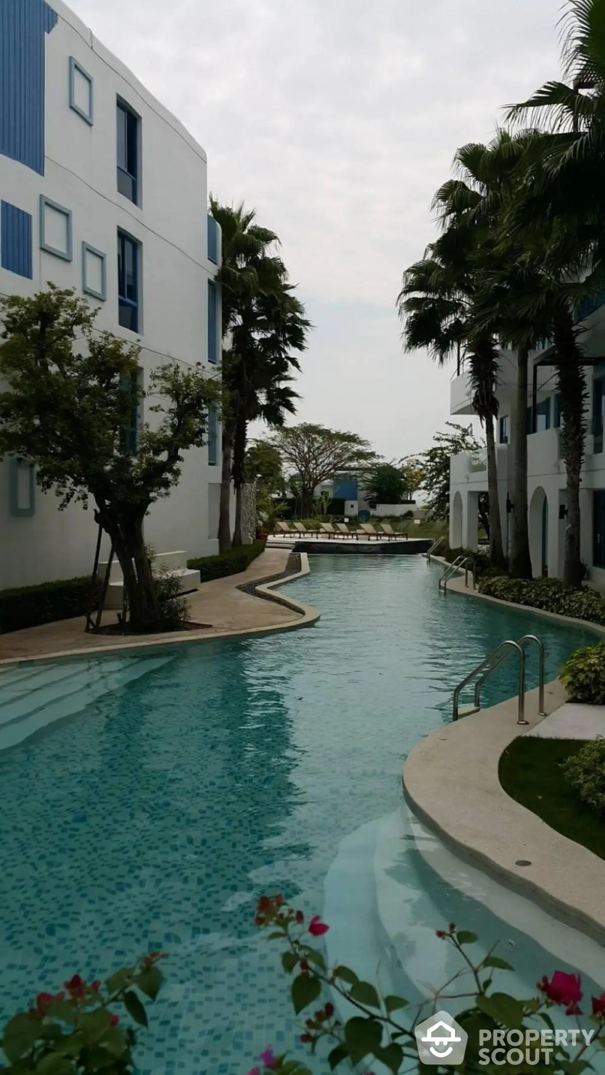 Luxurious residential pool area with modern architecture and lush greenery