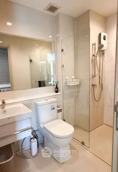 Modern bathroom with glass shower, sleek fixtures, and neutral tones for a contemporary feel.