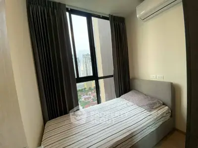 Cozy bedroom with city view and modern air conditioning unit