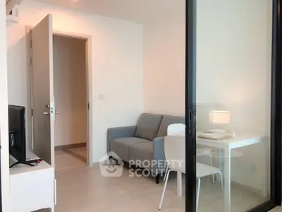 Modern living room with cozy sofa and dining area in open layout apartment.