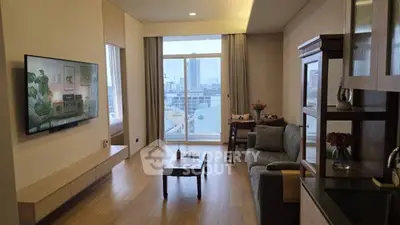 Modern living room with city view, featuring sleek furniture and large wall-mounted TV.